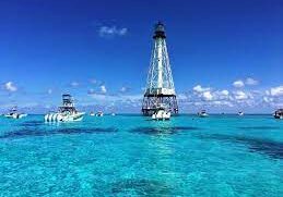 A group of boats floating on top of the ocean.